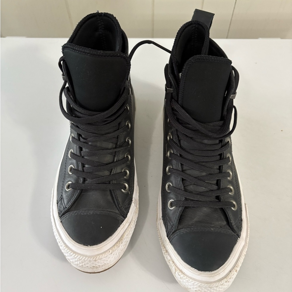 Converse Black High-Tops counter climate